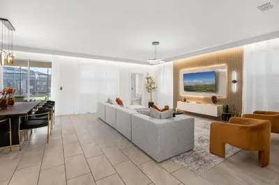 a living room with a couch and a table at 2858 Storey Lake brand new 19guests pool game room in Kissimmee
