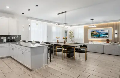 a kitchen and dining room with a table and chairs at 2858 Storey Lake brand new 19guests pool game room in Kissimmee