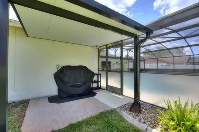 an empty patio with a cover on the side of a building at Beautiful Indian Ridge Home - Close to Disney in Orlando