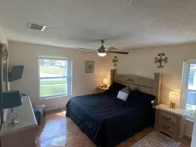 a bedroom with a bed and a ceiling fan at Beautiful Indian Ridge Home - Close to Disney in Orlando