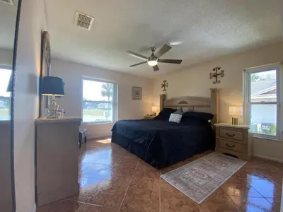 a bedroom with a bed and a ceiling fan at Beautiful Indian Ridge Home - Close to Disney in Orlando