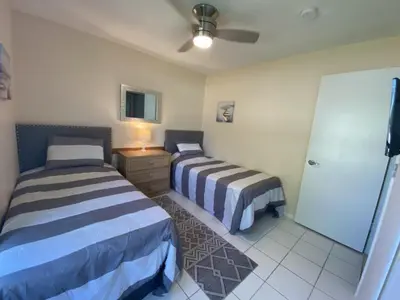a bedroom with two beds and a ceiling fan at Beautiful Indian Ridge Home - Close to Disney in Orlando