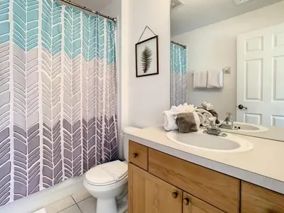a bathroom with a sink and a toilet and a shower at Celtic Palms: Private Pool & Near Disney Magic in Kissimmee