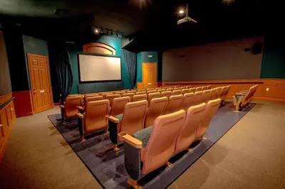 an empty auditorium with chairs and a projection screen at Celtic Palms: Private Pool & Near Disney Magic in Kissimmee