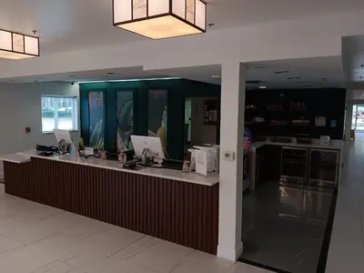 a restaurant with a counter with computers on it at Montreal Suites Orlando in Orlando