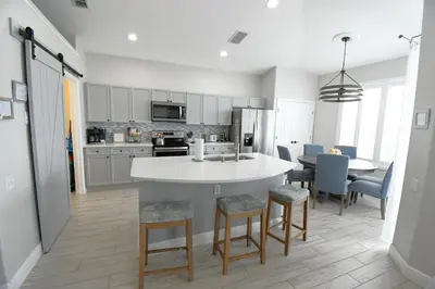 a kitchen with a large white island in a room at Best deal on Windsor Palms South facing pool in Kissimmee