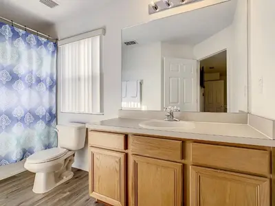 a bathroom with a sink and a toilet and a mirror at Old Town and Food trucks around the corner in Orlando