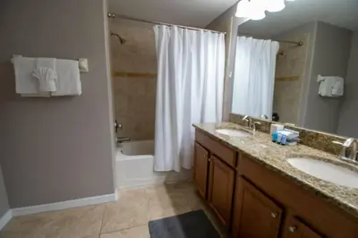 a bathroom with two sinks and a tub and a shower at Great deal townhome on Paradise Palms in Kissimmee