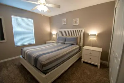 a bedroom with a bed and a ceiling fan at Great deal townhome on Paradise Palms in Kissimmee