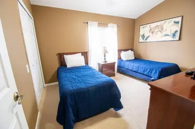 a bedroom with two beds with blue sheets in it at Great place to stay close to Disney Parks in Kissimmee
