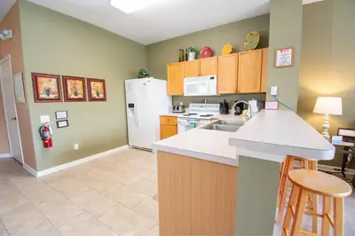 a kitchen with a sink and a white refrigerator at Great place to stay close to Disney Parks in Kissimmee