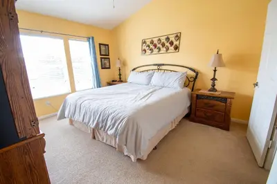a bedroom with a large bed and a window at Great place to stay close to Disney Parks in Kissimmee