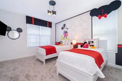 a bedroom with two beds and a mural of mickey mouse at Serene Rhyme Escape in Kissimmee