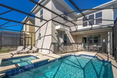 a swimming pool in front of a house at Serene Rhyme Escape in Kissimmee