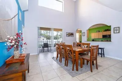 a dining room with a table and chairs at Ruby Reds Escape in Kissimmee