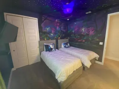 two beds in a room with a mermaid mural at Elegant Family Home | Pool, Spa & Themed Rooms in Orlando