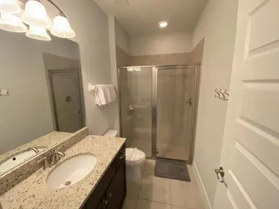 a bathroom with a sink and a shower at Elegant Family Home | Pool, Spa & Themed Rooms in Orlando