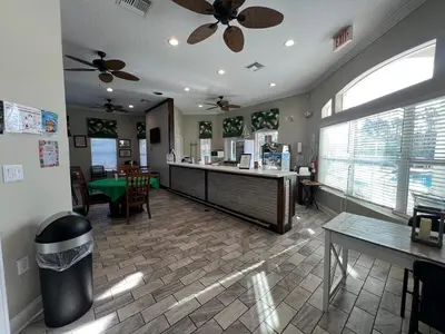 a restaurant with a cash counter and a table at Four Seasons Vacation, heated Pool, 3mile 2 Disney in Kissimmee
