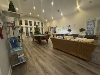 a living room with couches and a pool table at 4 Bedroom 3 Bathroom Villas At SevenDwarfs 20-102 in Kissimmee