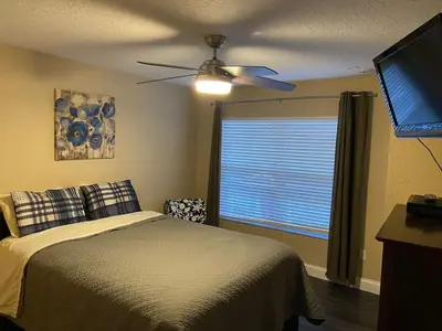 a bedroom with a bed and a ceiling fan at 4 Bedroom 3 Bathroom Villas At SevenDwarfs 20-102 in Kissimmee