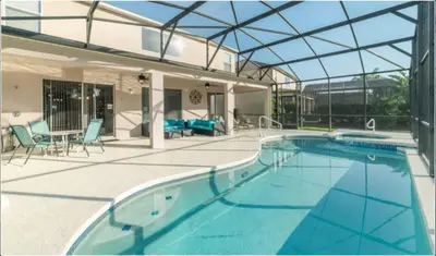a swimming pool in a house with a glass roof at Emerald Island Getaway – Sleeps 13! in Kissimmee
