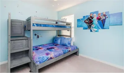 a bedroom with a bunk bed with a ladder and a mural at Emerald Island Getaway – Sleeps 13! in Kissimmee