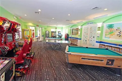 a gaming room with a pool table and arcade games at Family Villa Near Disney with Private Pool in Kissimmee