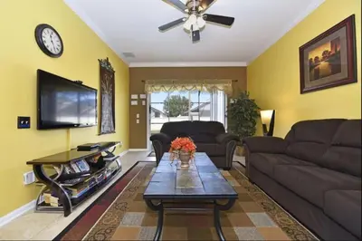 a living room with a couch and a table at Family Villa Near Disney with Private Pool in Kissimmee