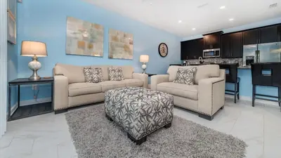 a living room with two couches and a table at Gatsby Escape: Private Pool Near Disney & Resorts in Kissimmee