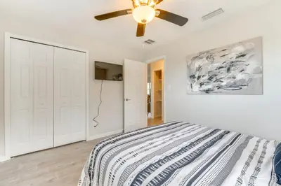 a bedroom with a bed and a ceiling fan at Nature-Packed Family Escape Near Lake Tohopekaliga in Kissimmee