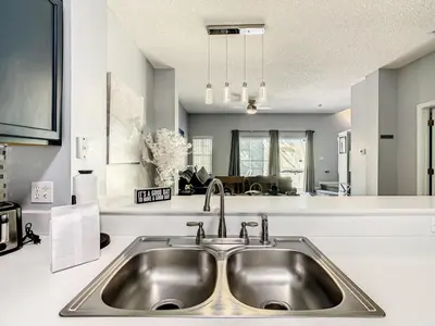 a kitchen with a stainless steel sink in a kitchen at Hogwarts Escape: Magical Retreat Near Disney in Kissimmee