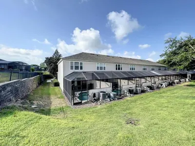 a large white building with a large yard at Krista's Tropical Escape: Resort Stay Near Disney in Kissimmee