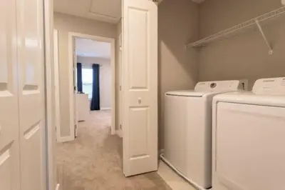 a laundry room with a washer and dryer at Prime Location 4BD Townhome with pool and Grill in Kissimmee