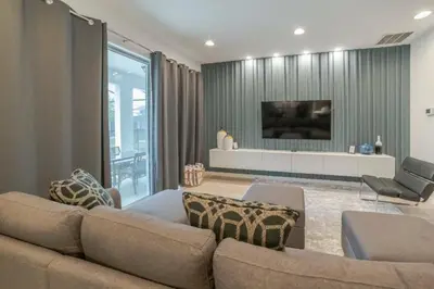 a living room with a couch and a tv at Mario Bros Game room 8BD Pool Movie Room 2622 in Kissimmee