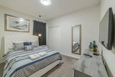 a bedroom with a bed and a dresser in it at Mario Bros Game room 8BD Pool Movie Room 2622 in Kissimmee