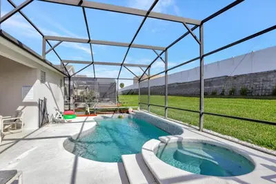a swimming pool in the middle of a backyard at Luxury Pool Home 3 Miles from Disney & More! in Kissimmee