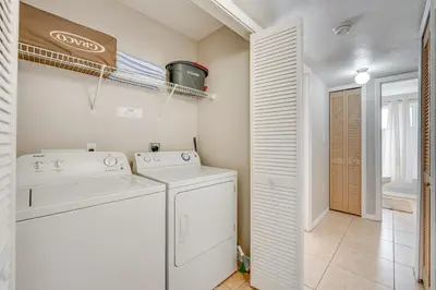 a laundry room with a washer and dryer at 7 Mi to Disney Condo with Pool and Hot Tub Access! in Kissimmee