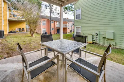 a table and chairs on the back porch of a house at 7 Mi to Disney Condo with Pool and Hot Tub Access! in Kissimmee