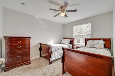 a bedroom with two beds and a ceiling fan at 7 Mi to Disney Condo with Pool and Hot Tub Access! in Kissimmee