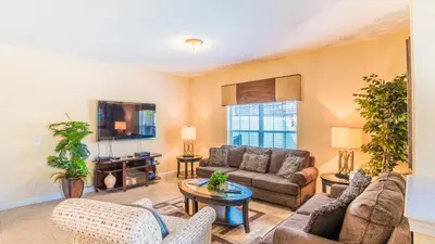a living room with a couch and a tv at CPR8951 in Kissimmee