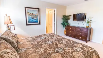 a bedroom with a bed and a flat screen tv at CPR8951 in Kissimmee