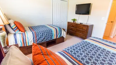 a bedroom with two beds and a flat screen tv at CPR8951 in Kissimmee