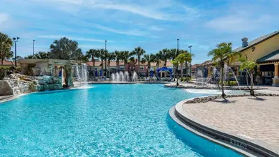 a swimming pool with a waterfall in a resort at CPR8951 in Kissimmee