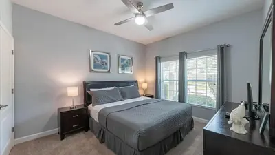 a bedroom with a bed and a ceiling fan at CUP8946 in Kissimmee