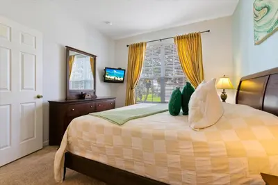 a bedroom with a bed with a window and a television at MNL2678 in Orlando