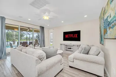 a living room with two couches and a tv at LAKE VILLA 6bd, all un-suite, pool, spa, grill in Kissimmee