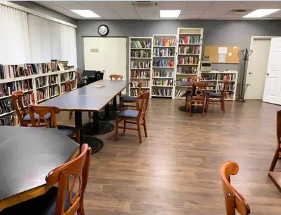 a library with tables and chairs and shelves of books at 2950 COTTAGE GROVE COURT ORLANDO 3BED in Orlando