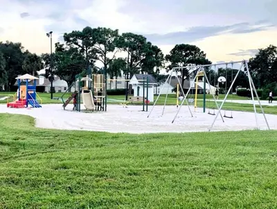 a park with a playground with swings at 2950 COTTAGE GROVE COURT ORLANDO 3BED in Orlando