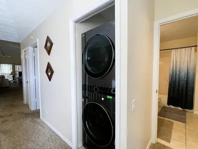 a black washer and dryer in a room at 2950 COTTAGE GROVE COURT ORLANDO 3BED in Orlando