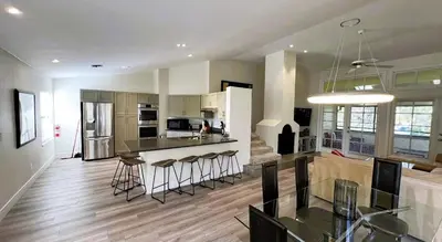 a kitchen and living room with a table and chairs at 2971 COTTAGE GROVE COURT ORLANDO 3BED in Orlando